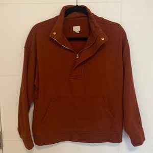 Rust color quarter zip with front pocket and button at top